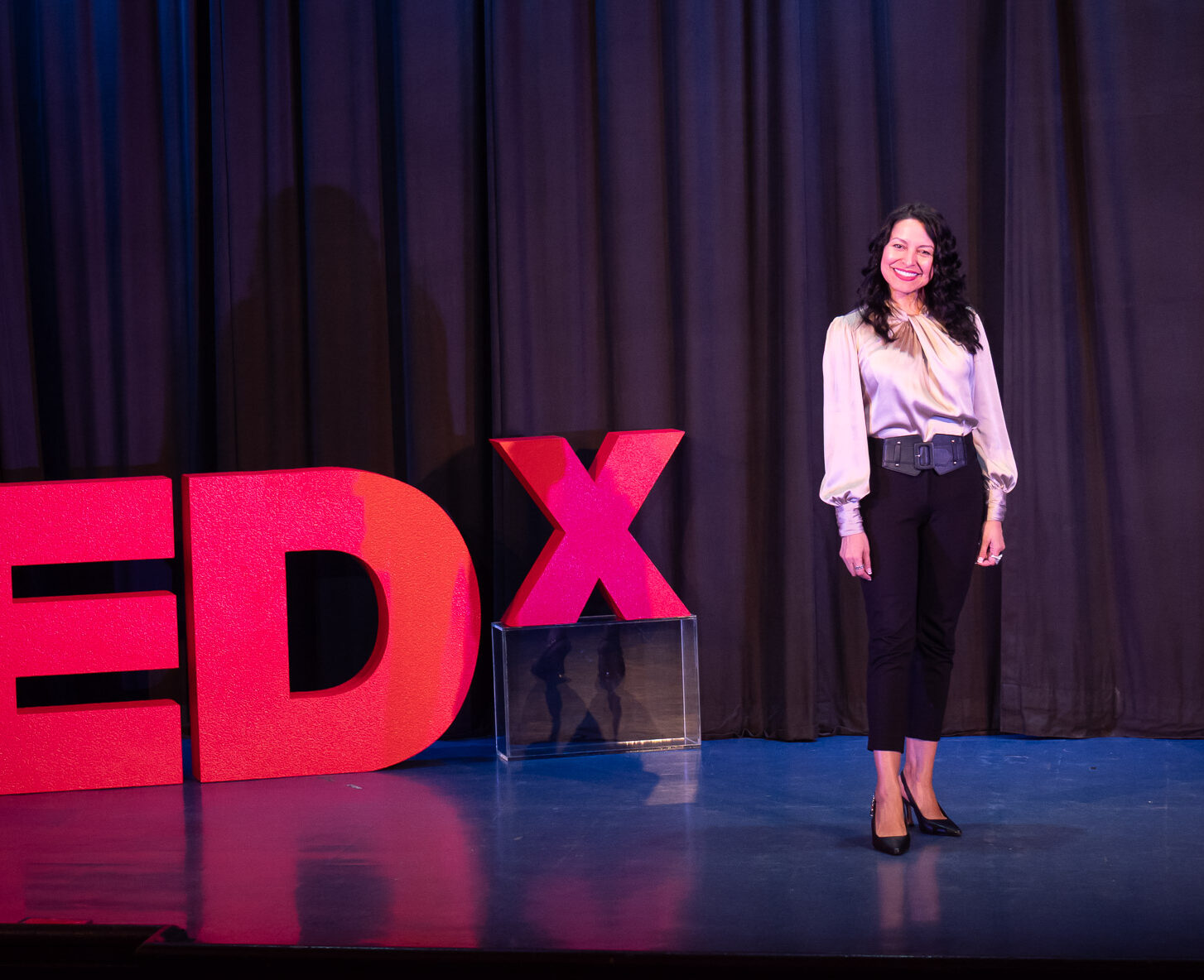 Emcee Mariza Brussolo hosting a TEDx event