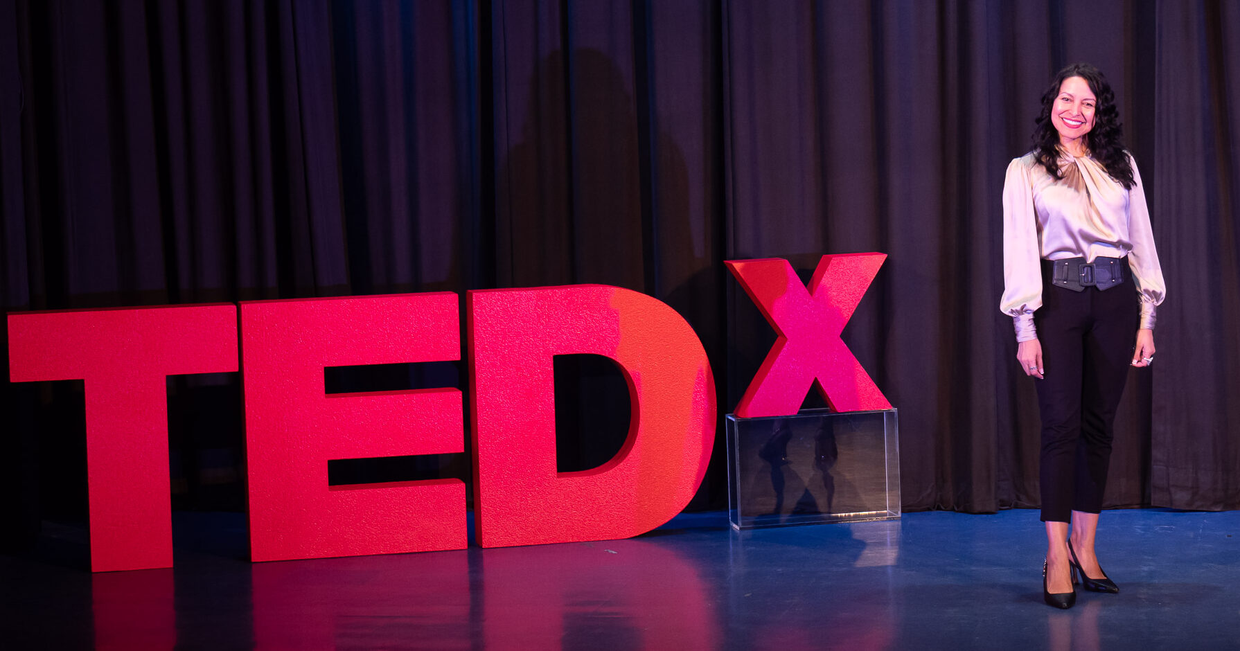 woman on stage at tedx event